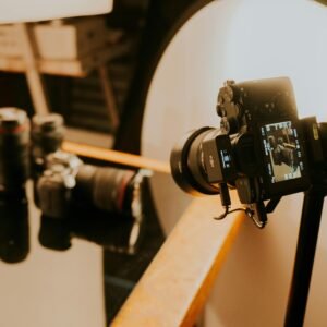 Close-up of a professional photography setup with cameras and lenses under studio lighting.